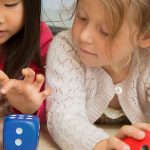 奥格斯堡国际学校的2个小女孩玩玩具色子