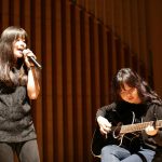 布兰克森霍尔亚洲学院的学生舞台上表演吉他和唱歌